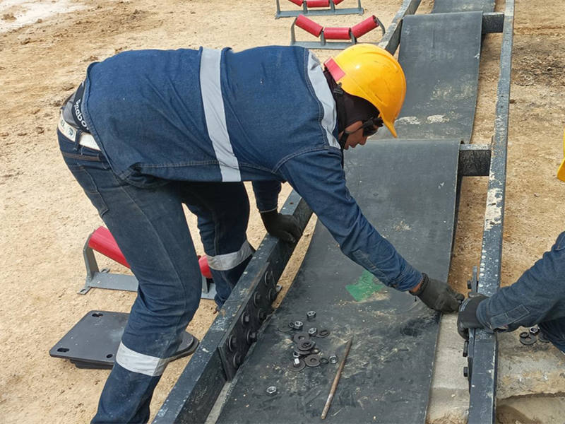 Workers disassemble mobile impact crusher