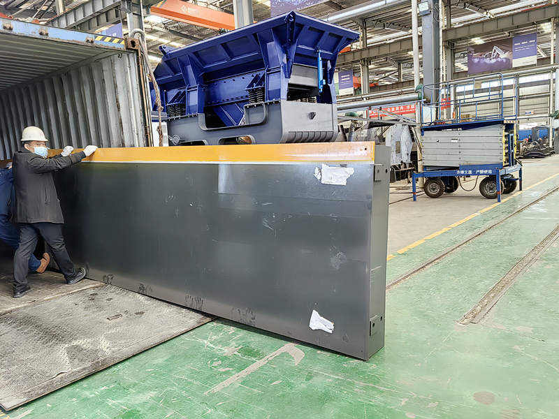 crusher component being loaded into container before shipment