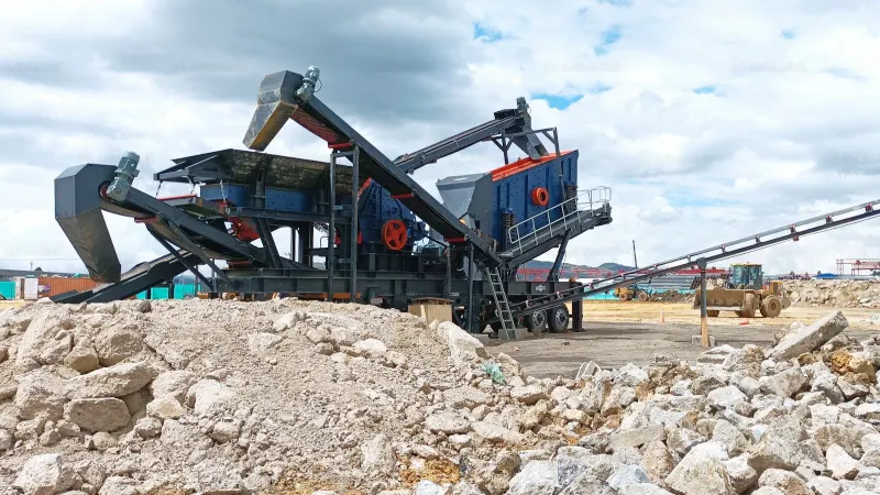 wheeled mobile crusher working at site crushing concrete waste